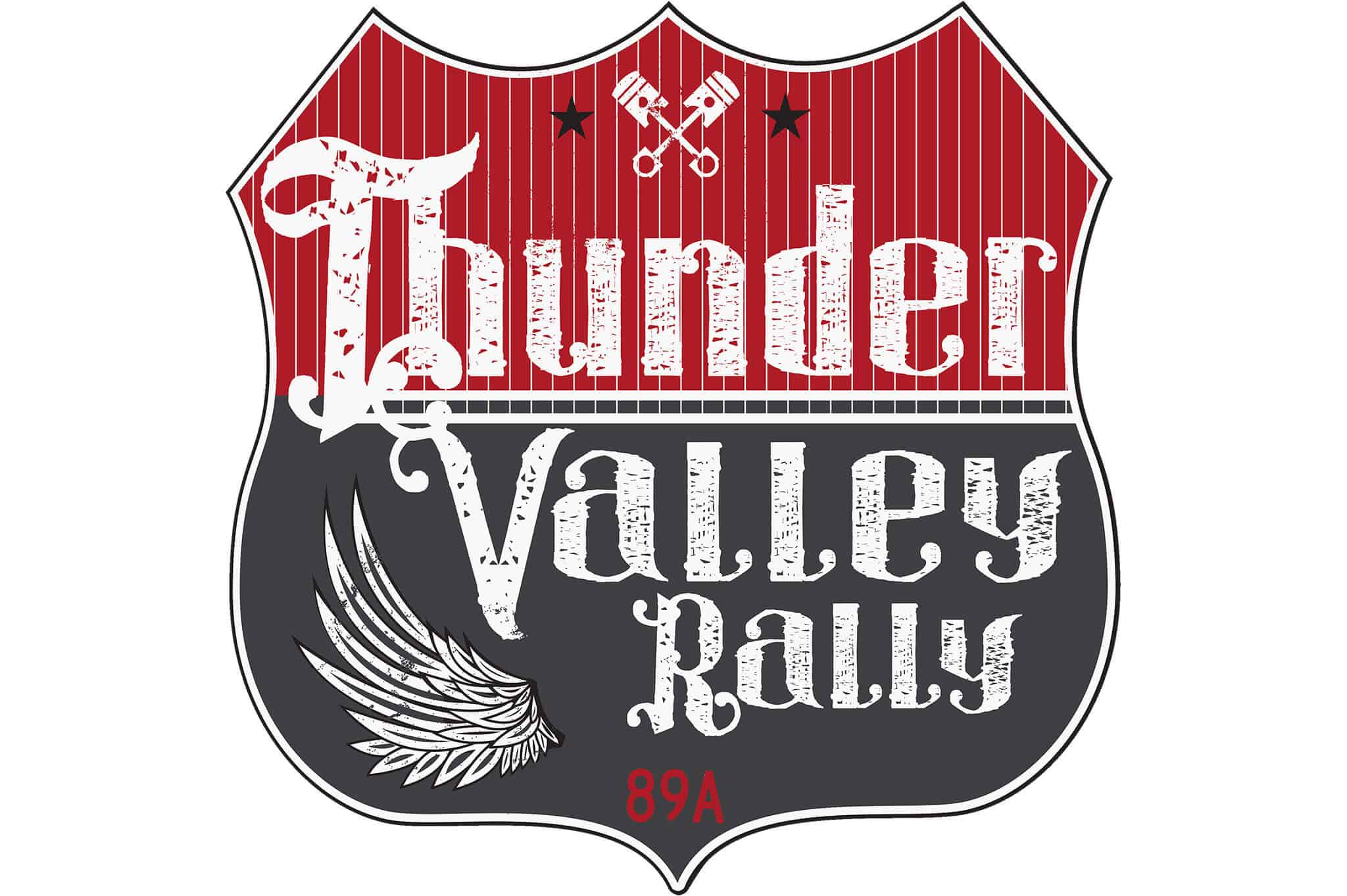 A shield-shaped logo for Thunder Valley Rally with a red and black background. The text "Thunder Valley Rally" is in a vintage, distressed font, accompanied by an image of angel wings. Two crossed wrenches and small stars are at the top, with "89A" at the bottom, promoting an unforgettable experience.